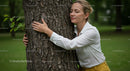 Woman Embracing Tree in Lush Green Forest