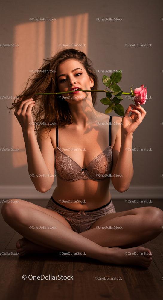 Elegant Woman Holding Pink Rose in Soft Evening Light