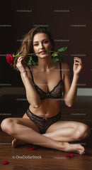 Elegant Woman in Black Lingerie Holding Red Rose