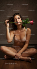 Sensual Woman with Rose in Intimate Setting