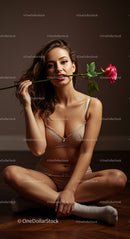 Elegant Woman in Lingerie Holding a Red Rose