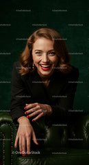 Smiling Woman in Black Jacket on Green Couch
