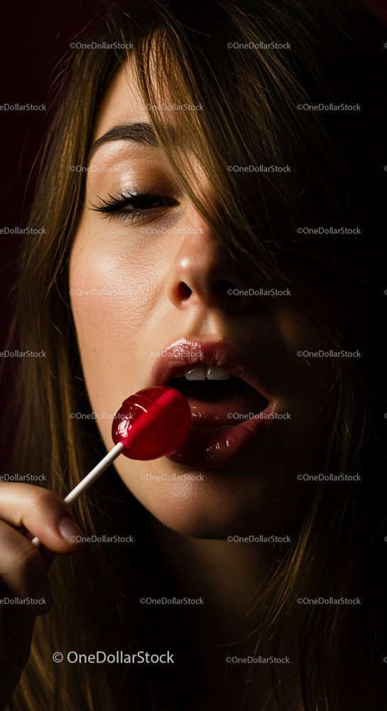 Sensual Portrait of a Woman with Red Lollipop