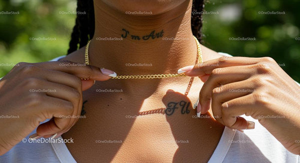 Elegant Gold Necklace and Tattoos in Sunlit Garden