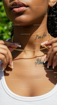 Stylish Woman with Tattoos and Gold Chain Necklace