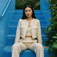 Stylish Woman in Beige Outfit on Blue Steps