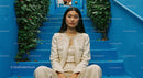 Confident Woman in Elegant Attire on Blue Stairs