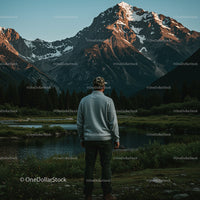 Man Admiring Majestic Mountain Landscape at Sunset