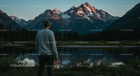 Man Admiring Snow-Capped Mountains by Serene Lake