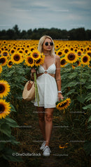 Fashionable Woman in Sunflower Field on a Sunny Day