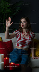 Young Woman in Red Striped Top and Denim in Cozy Interior