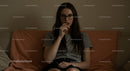 Young Woman in Glasses Pondering on a Cozy Sofa
