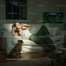 Woman Relaxing with Headphones and Dog on Cozy Sofa