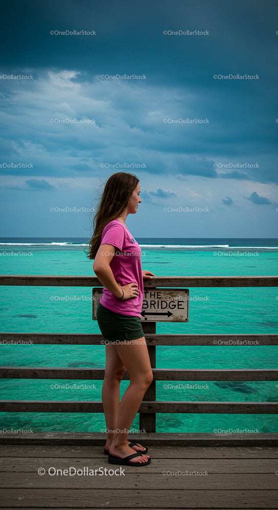 Woman in Pink Shirt Overlooking Turquoise Ocean