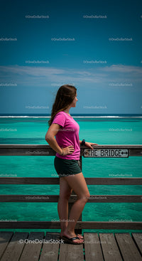 Woman Enjoying Ocean View from a Wooden Pier