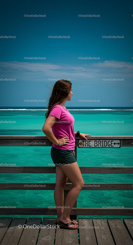 Woman Enjoying Ocean View from a Wooden Pier