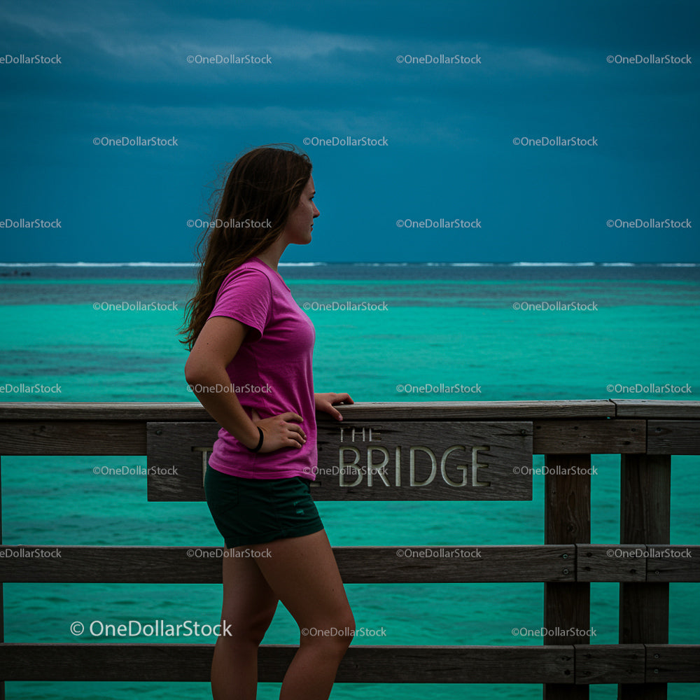 Woman in Pink Shirt Admiring Turquoise Ocean View