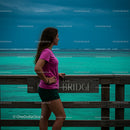 Woman in Pink Shirt Admiring Turquoise Ocean View