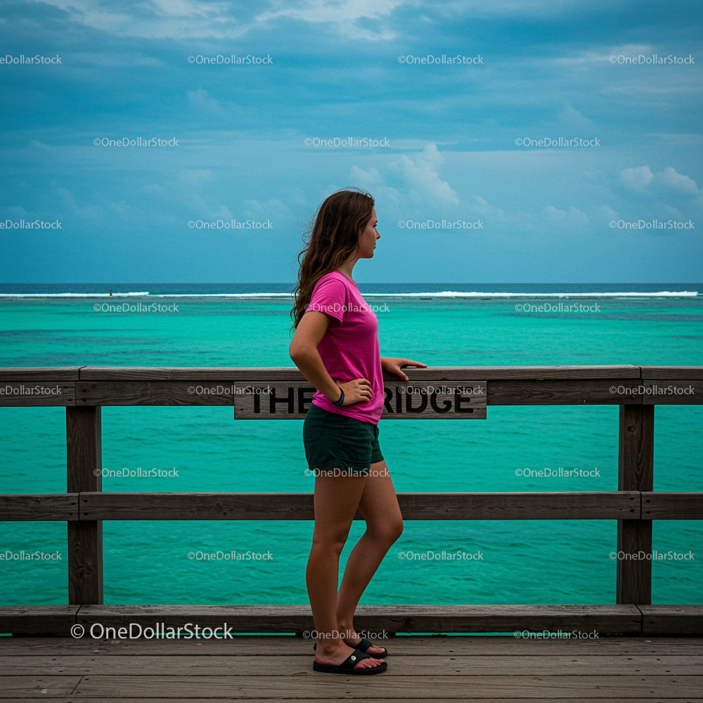 Woman Relaxing by Turquoise Ocean in Casual Summer Attire