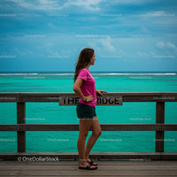 Woman Relaxing by Turquoise Ocean in Casual Summer Attire