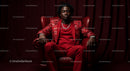 Confident Man in Elegant Red Suit Sitting in Leather Chair
