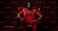 Confident Man in Elegant Red Suit Sitting in Leather Chair