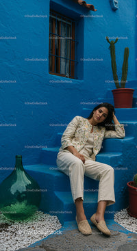 Woman Relaxing by Vibrant Blue Wall with Cactus