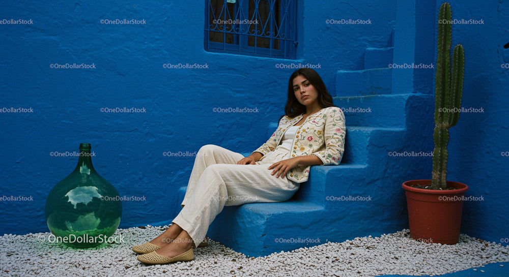 Woman Relaxing by Vibrant Blue Wall with Cactus
