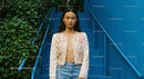 Fashionable Woman in Embroidered Jacket on Blue Stairs