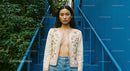 Woman in Embroidered Jacket on Blue Staircase