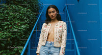 Fashion Model in Embroidered Jacket on Blue Staircase