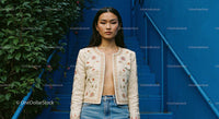 Fashionable Woman in Embroidered Jacket on Blue Stairs