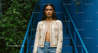 Confident Woman in Embroidered Jacket on Blue Stairs