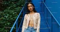 Stylish Woman in Embroidered Jacket on Blue Urban Stairs