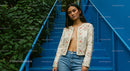 Stylish Woman in Embroidered Jacket on Blue Stairs
