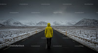 Person in Yellow Jacket Facing Snowy Mountain Road