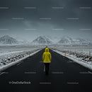 Person in Yellow Jacket on Snowy Road with Mountain Vista