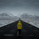 Traveler in Yellow Jacket on Empty Winter Road
