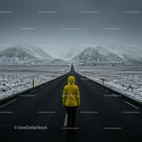 Traveler in Yellow Jacket on Empty Winter Road