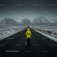 Lone Traveler on Snowy Road with Majestic Mountain View