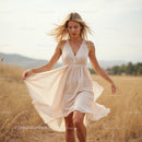 Blonde Woman in Flowing Beige Summer Dress in Countryside