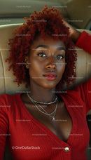 Elegant Woman with Red Curly Hair and Stylish Jewelry