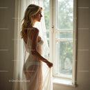 Blonde Woman in Sheer Dress Standing by a Sunlit Window
