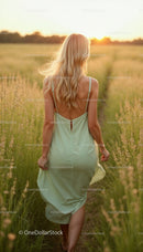 Woman in Mint Green Dress Walking Through Sunset Field