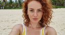Freckled Woman with Red Hair on Tropical Beach