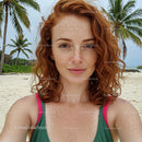 Portrait of Woman with Red Hair and Freckles on Tropical Beach