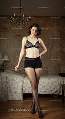 Elegant Woman in Lace Lingerie in Bedroom Setting