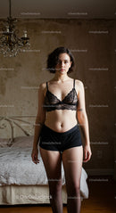 Woman in Black Lace Lingerie in Stylish Bedroom