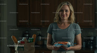 Smiling Woman in Modern Kitchen Holding Grocery Items