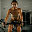 Focused Woman Sweating During Intense Indoor Cycling Workout